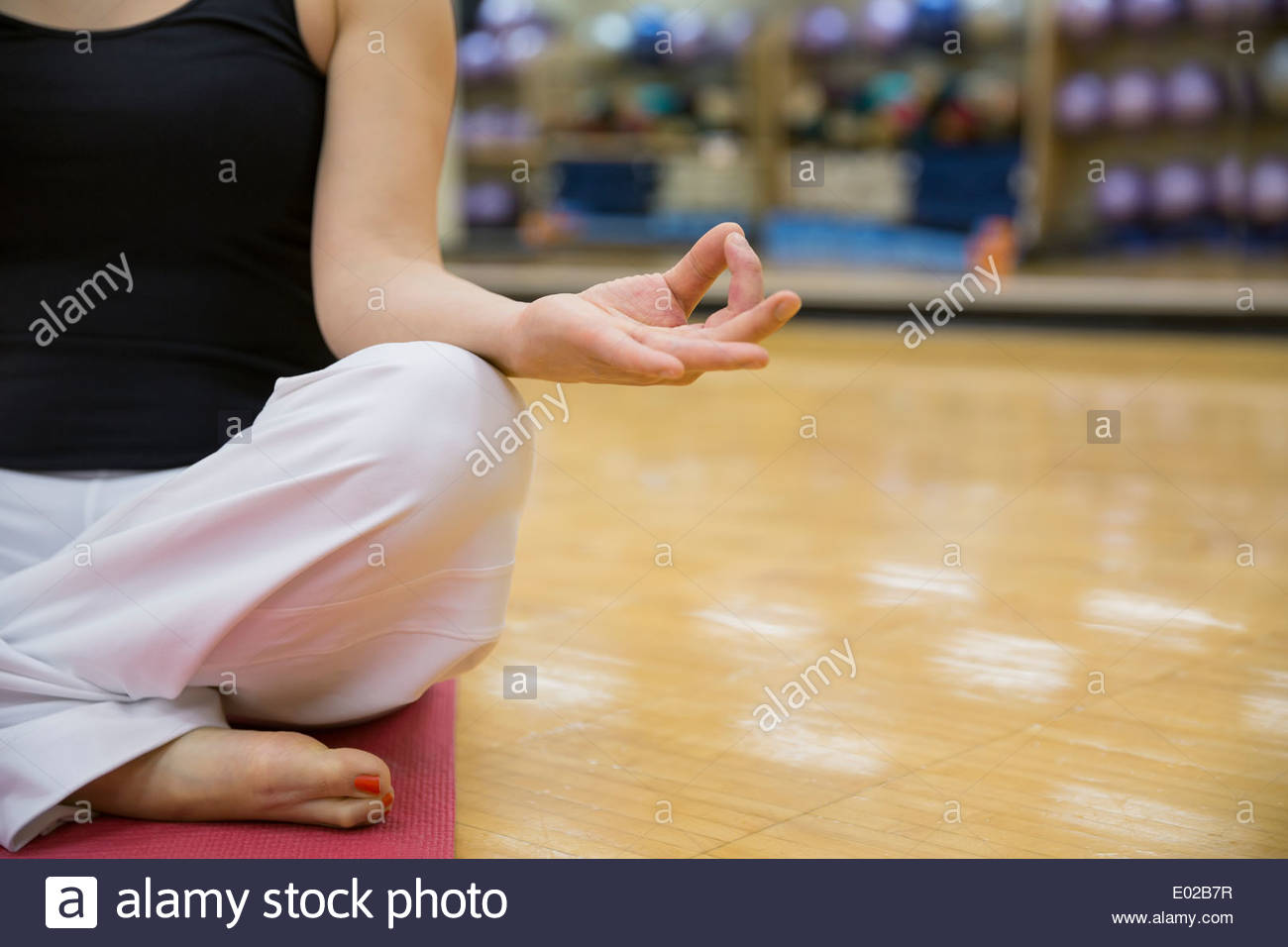 Close up of woman in lotus position Stock Photo