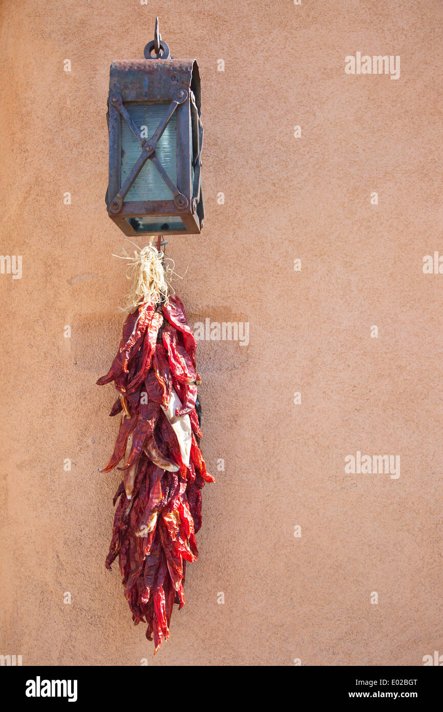 Ristra of dried chili peppers hanging on adobe wall in Santa Fe, New