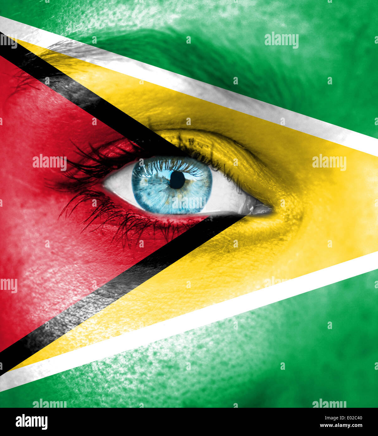 Woman face painted with flag of Guyana Stock Photo