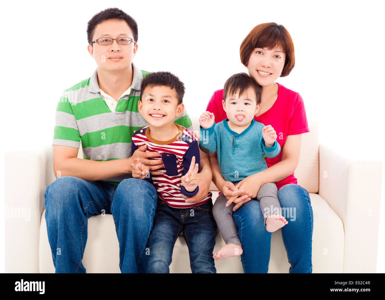 happy asian family sitting on a white leather sofa Stock Photo