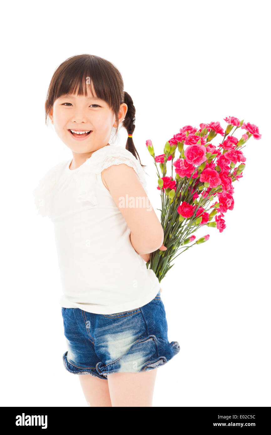 Smiling girl hiding a bouquet of carnations Stock Photo