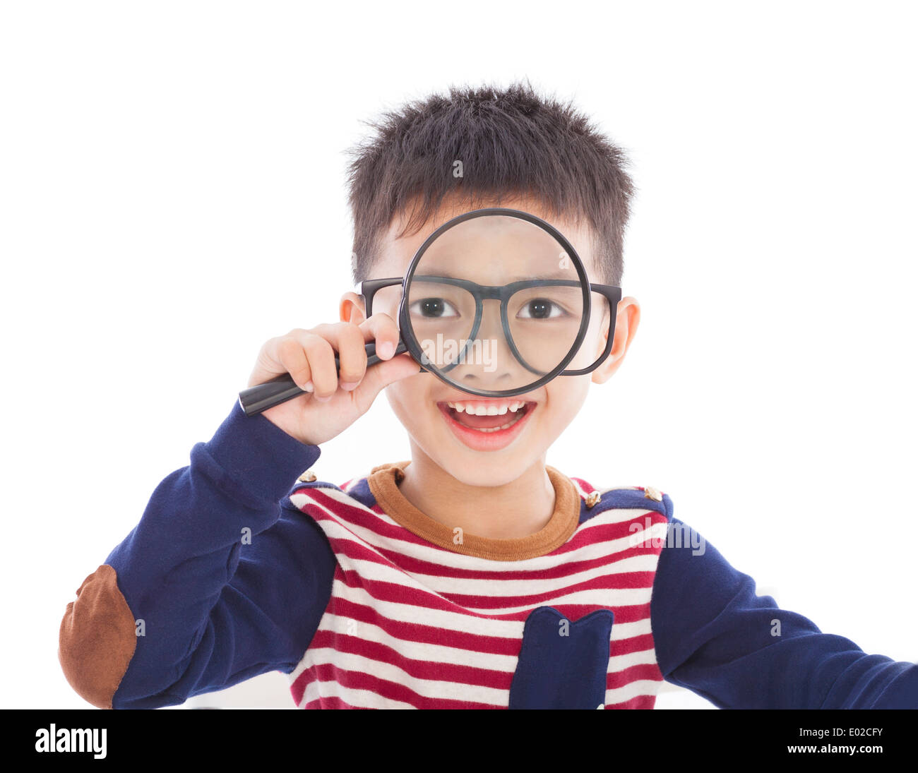adorable boy holding a magnifier and watching through Stock Photo