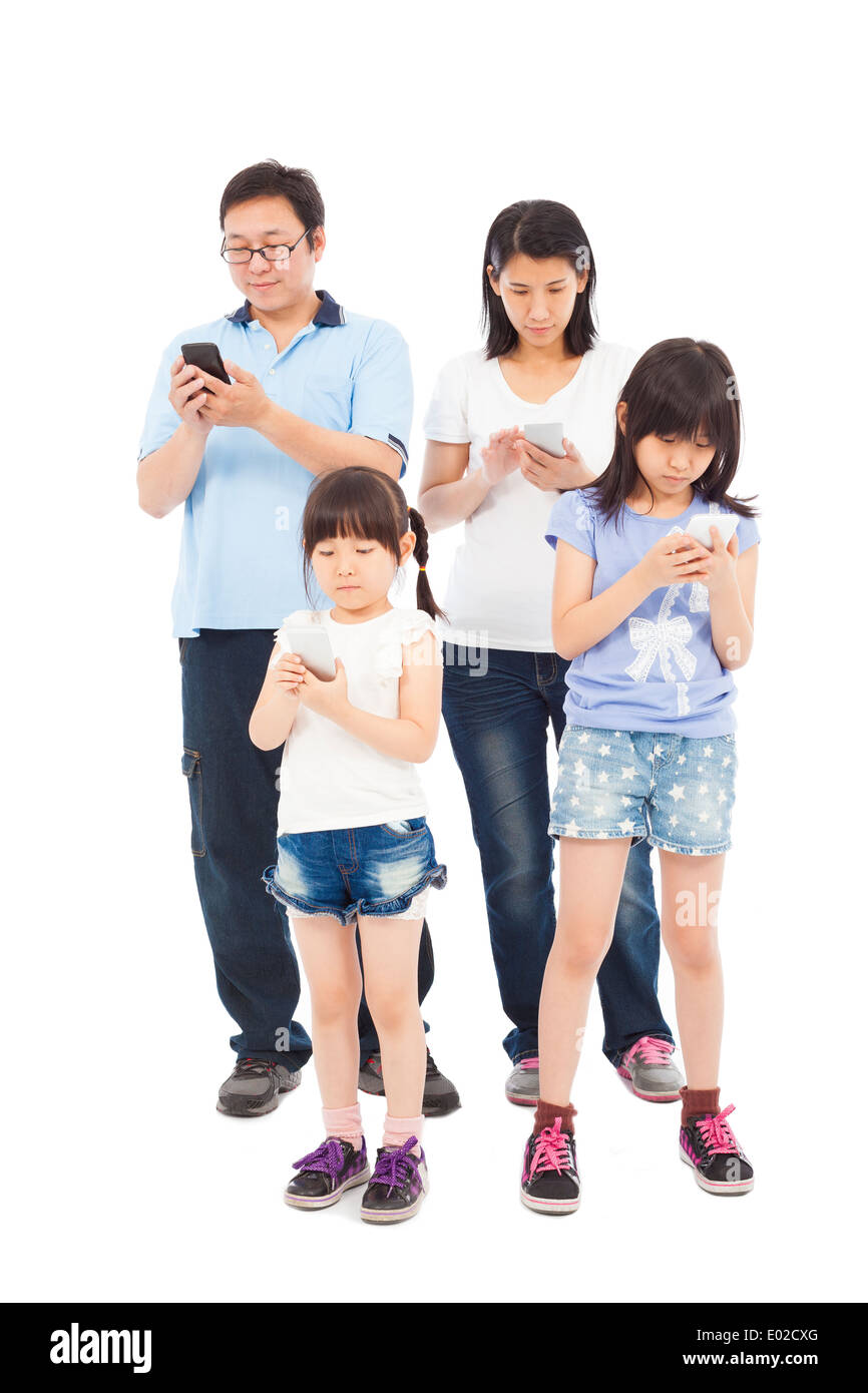Asian Family standing and using smart phone together Stock Photo