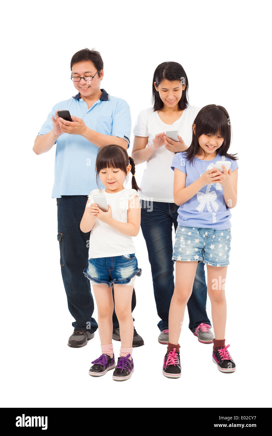 Happy Family standing and using smart phone together Stock Photo