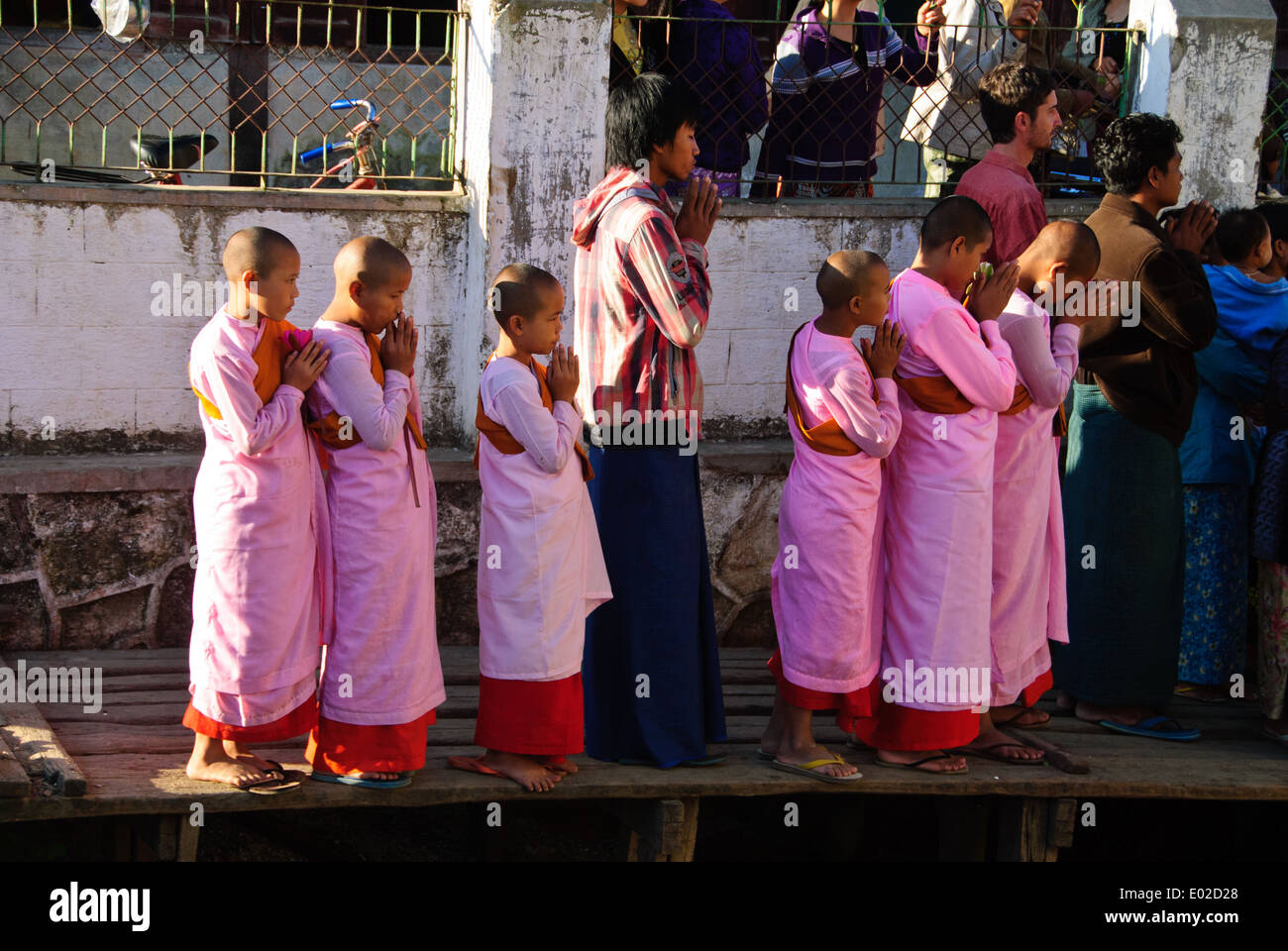 Novice nuns and the villagers waiting for the royal barge procession coming into the town. Stock Photo