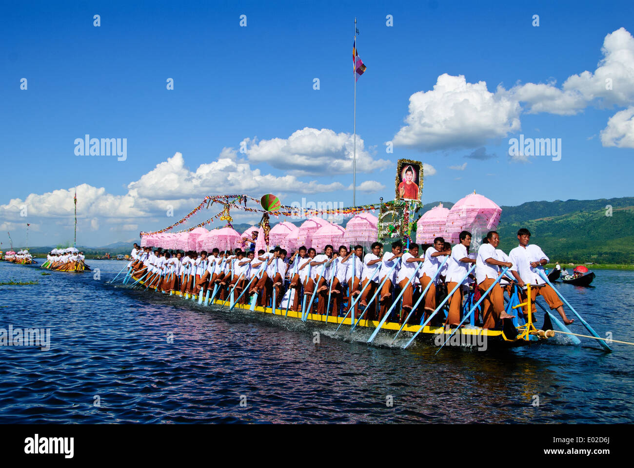 Leg-rowers moving forwards pulling the royal barge across Inle Lake during the festival. Stock Photo