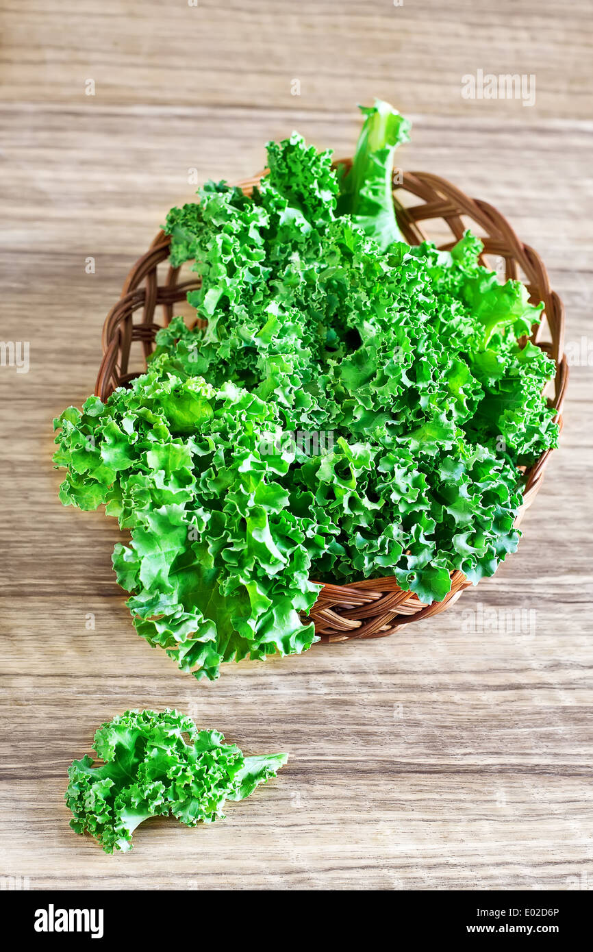 Fresh green kale leaves in basket. Selective focus. Stock Photo