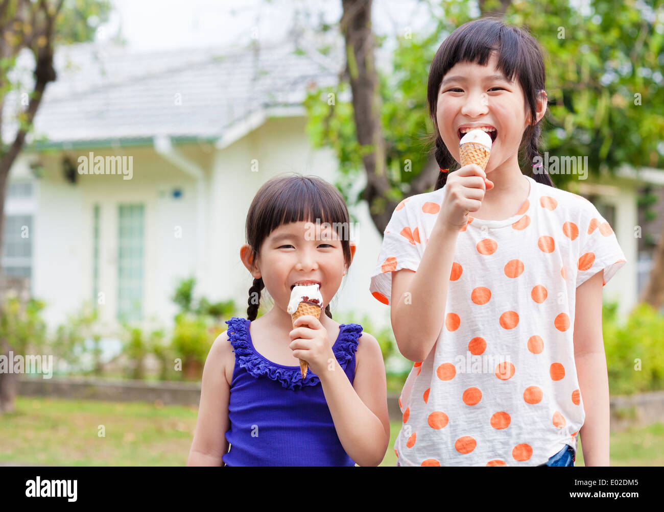 Cute little Girls Eating Ice Cream Stock Photo