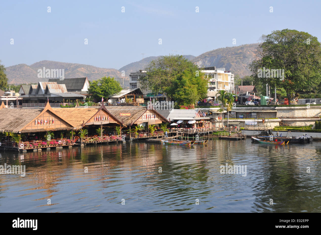 Restaurants and boats on the Mae Klong River, Kanchanaburi, Thailand. Stock Photo