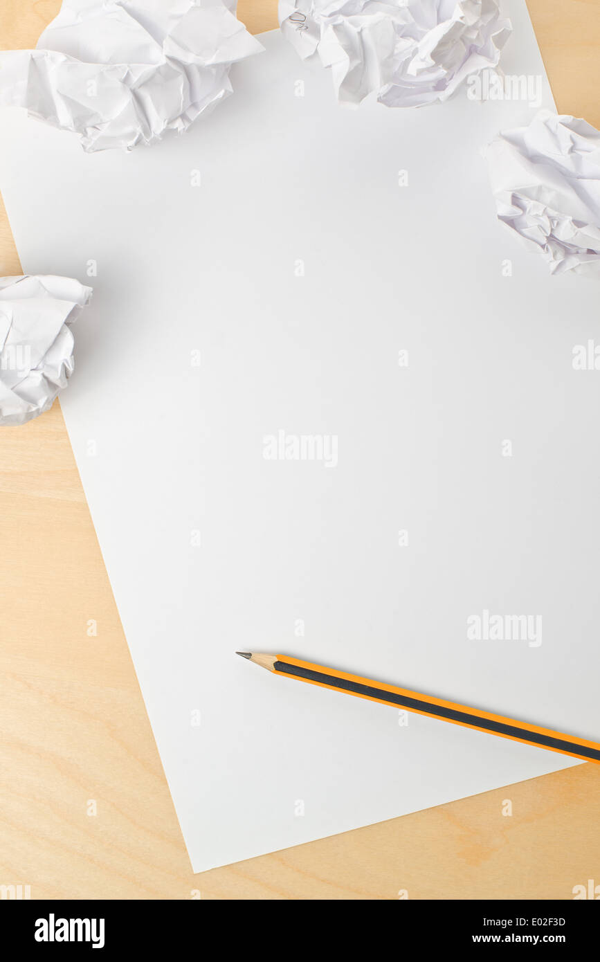 Writing concept. Crumpled paper with a sheet of white paper and pencil