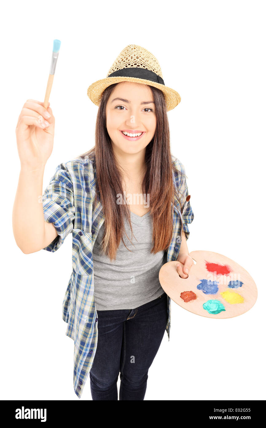 Female painter holding paintbrush and looking at camera Stock Photo Alamy