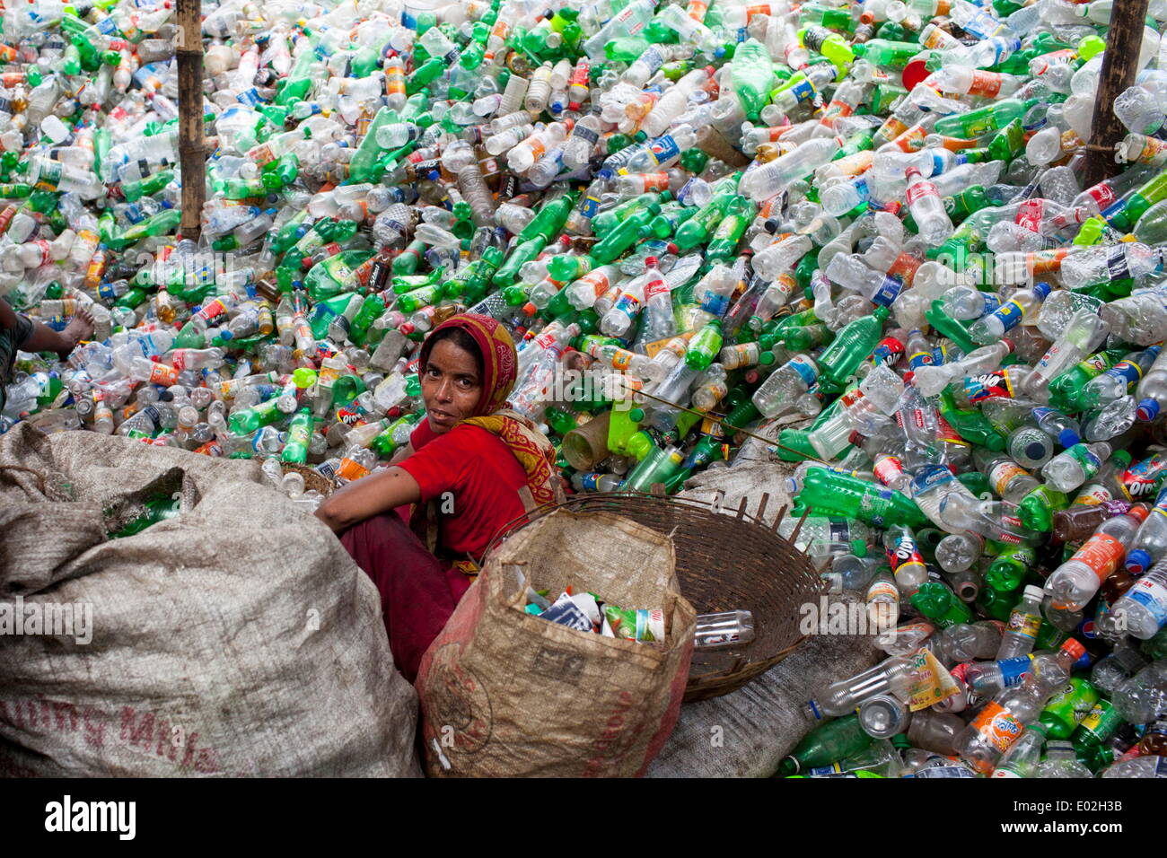 Dhaka, Bangladesh. 29th Apr, 2014. Bangladeshi women laborers sift through empty bottles at a