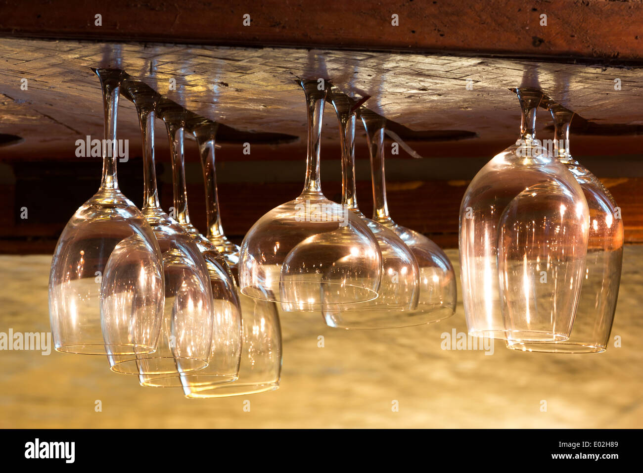 Empty glasses for alcohol beverage above a bar rack background Stock Photo