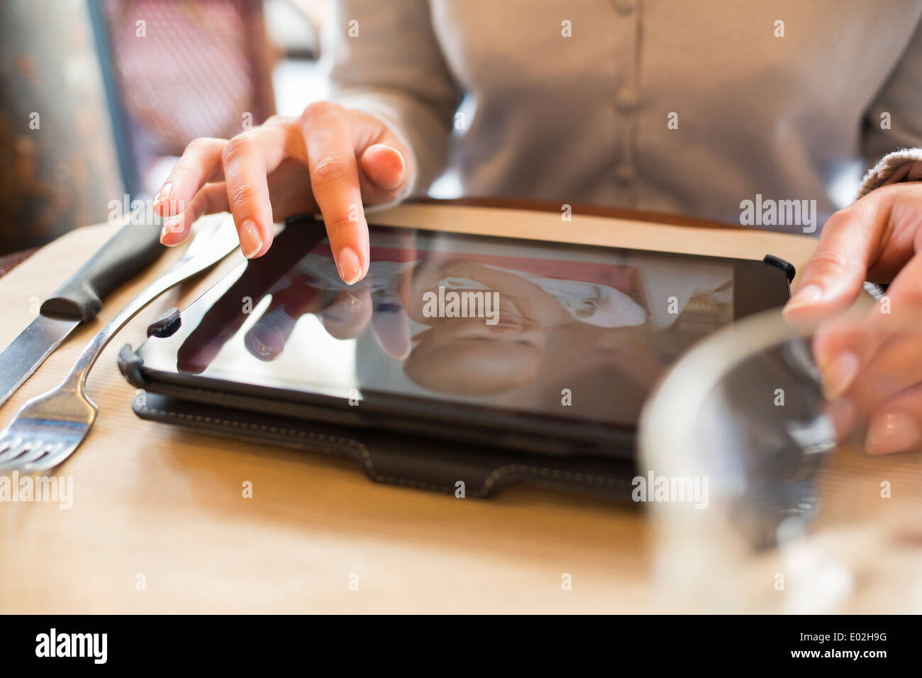 Female digital tablet computer bar restaurant Stock Photo