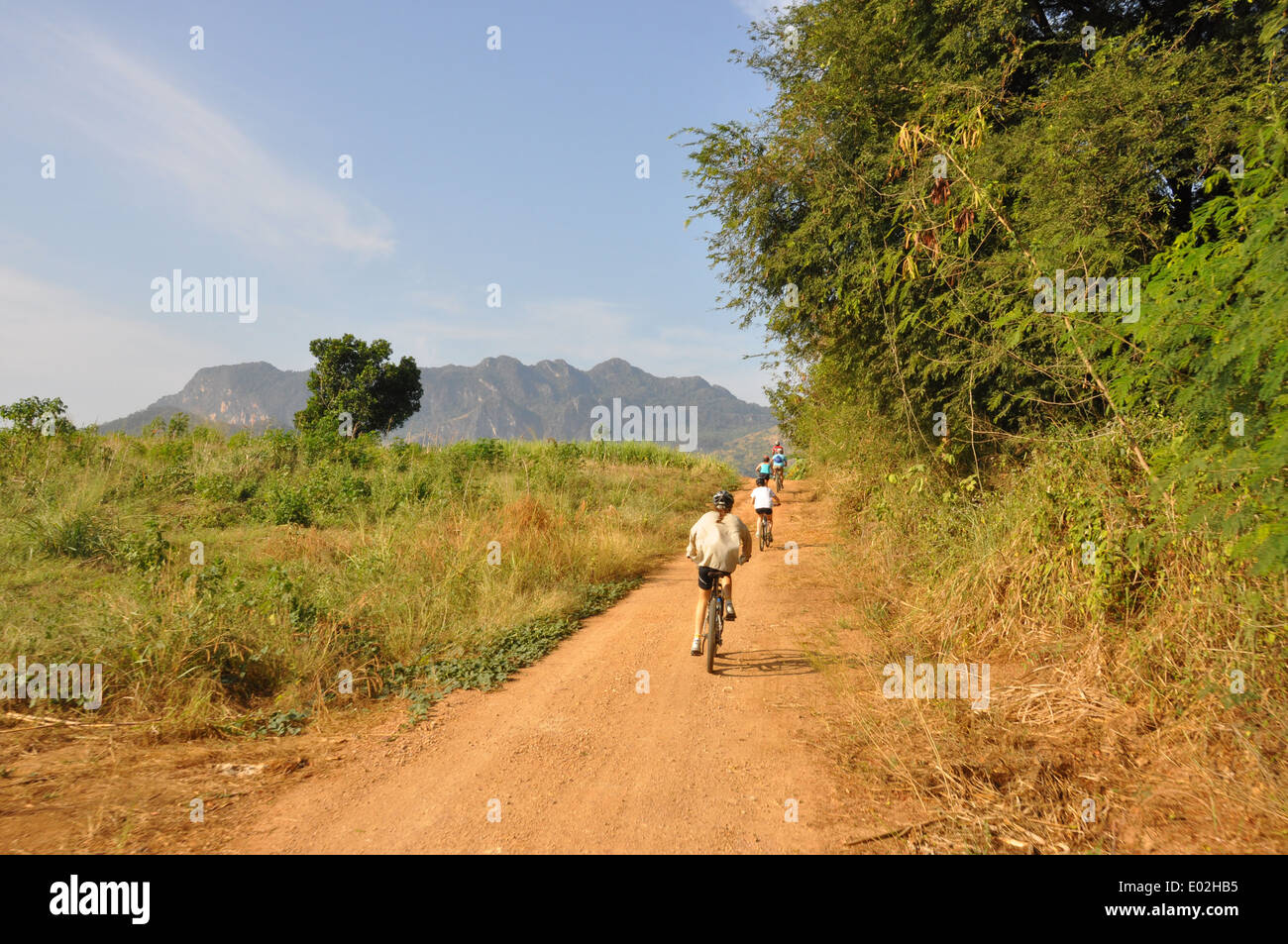 Cyclists cycling along a country road in rural Australia. Stock Photo