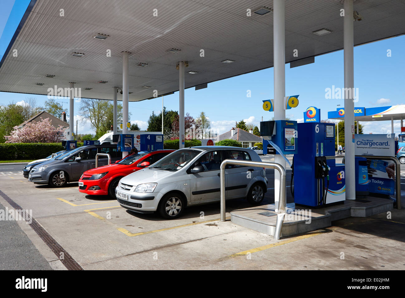 cars at a filling station forecourt pumps in northern ireland Stock Photo