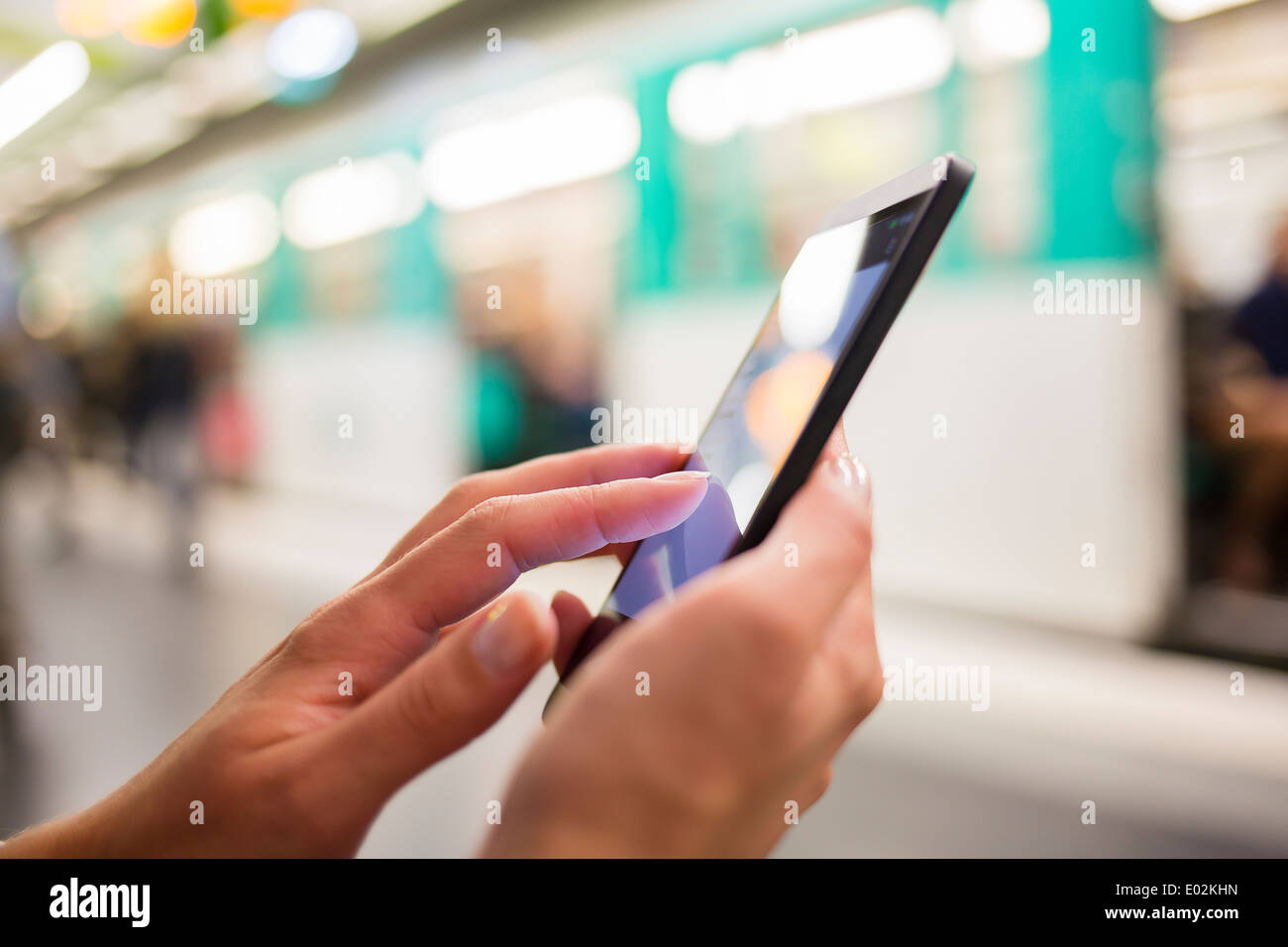 Female smartphone hand underground message sms e-mail Stock Photo