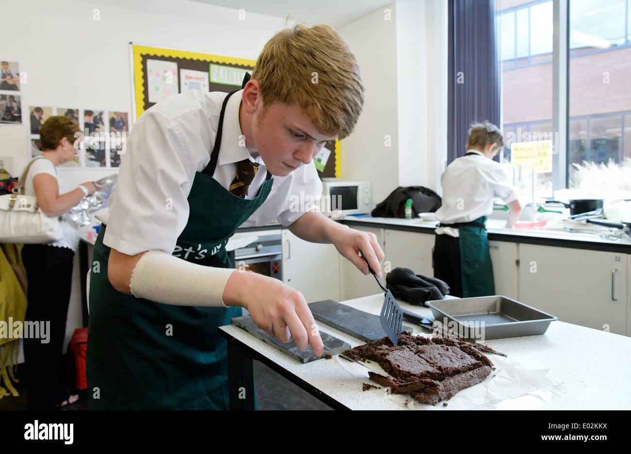 School pupils / students cooking during a home economics class at their Midlands school Stock Photo