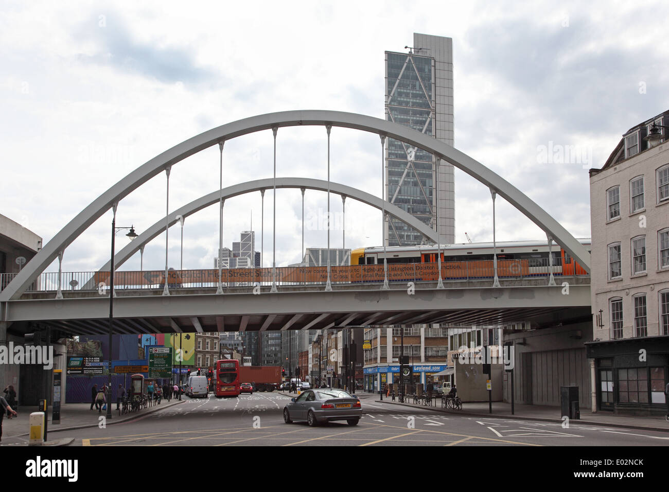 The London Overground rail line passes over Shoreditch High Street, via single span steel bridge. Broadgate Tower in background Stock Photo