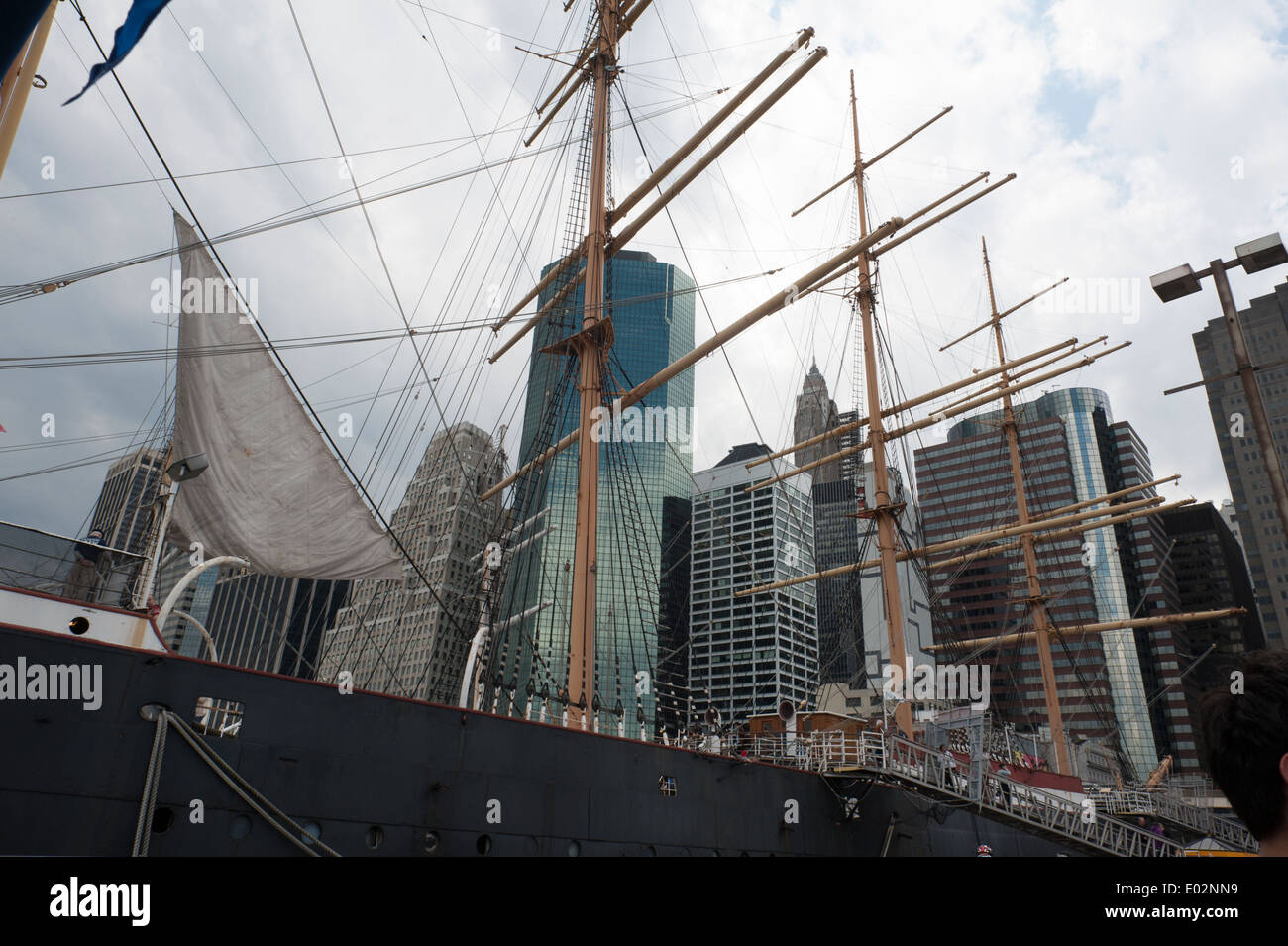 The masts of the South Street Seaport Museum's 102-year-old barque, Peking, with Financial District buildings behind the ship. Stock Photo