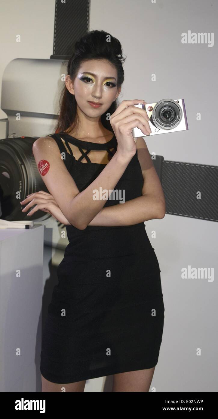 Taipei, Taiwan. 30th Apr, 2014. A model demonstrates a brand-new Leica T camera at a release ceremony in Taipei, southeast Taiwan, April 30, 2014. German camera manufacturer Leica released its latest T system cameras Wednesday at the Songshan Cultural Park in Taipei. The Leica T system features a 16.3-megapixel APS-C CMOS sensor in a minimalist design and supports wireless transmission of photographic works to users' mobile devices and social networks. Credit:  Huang Xiaoyong/Xinhua/Alamy Live News Stock Photo