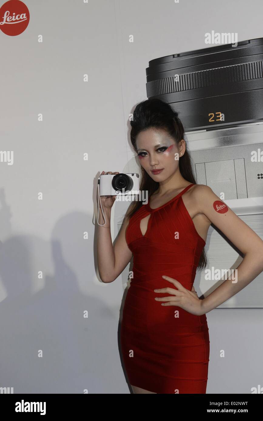 Taipei, Taiwan. 30th Apr, 2014. A model demonstrates a brand-new Leica T camera at a release ceremony in Taipei, southeast Taiwan, April 30, 2014. German camera manufacturer Leica released its latest T system cameras Wednesday at the Songshan Cultural Park in Taipei. The Leica T system features a 16.3-megapixel APS-C CMOS sensor in a minimalist design and supports wireless transmission of photographic works to users' mobile devices and social networks. Credit:  Huang Xiaoyong/Xinhua/Alamy Live News Stock Photo
