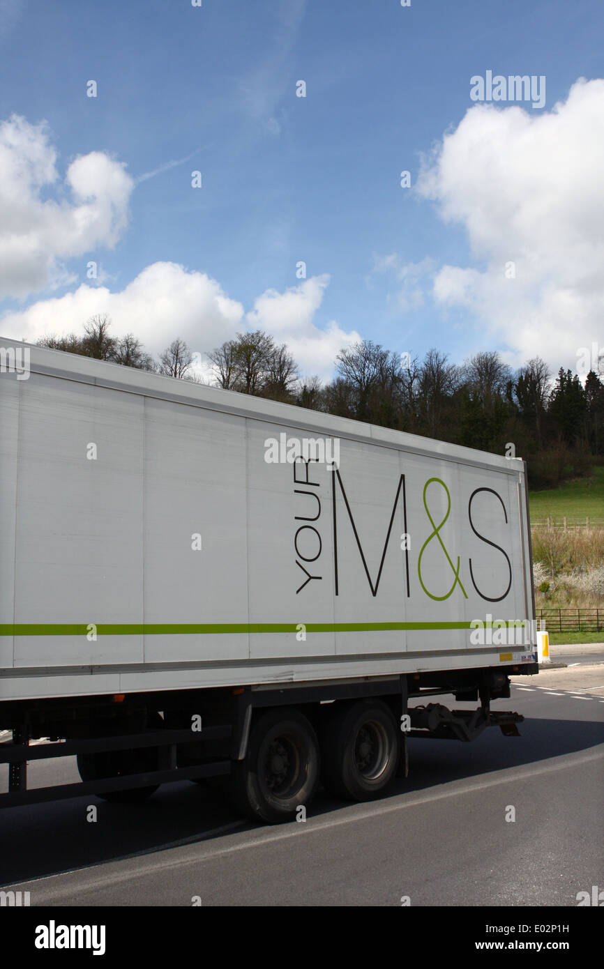 Paart of an M&S trailer being hauled by a truck traveling around a roundabout in Coulsdon, Surrey, England Stock Photo