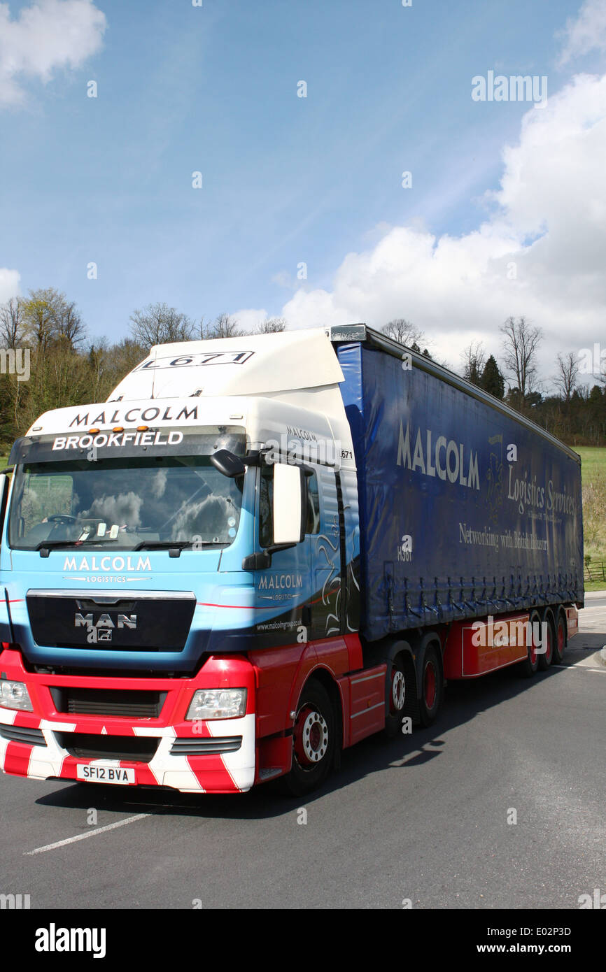 A Malcolm Logistics truck entering a roundabout in Coulsdon, Surrey, England Stock Photo