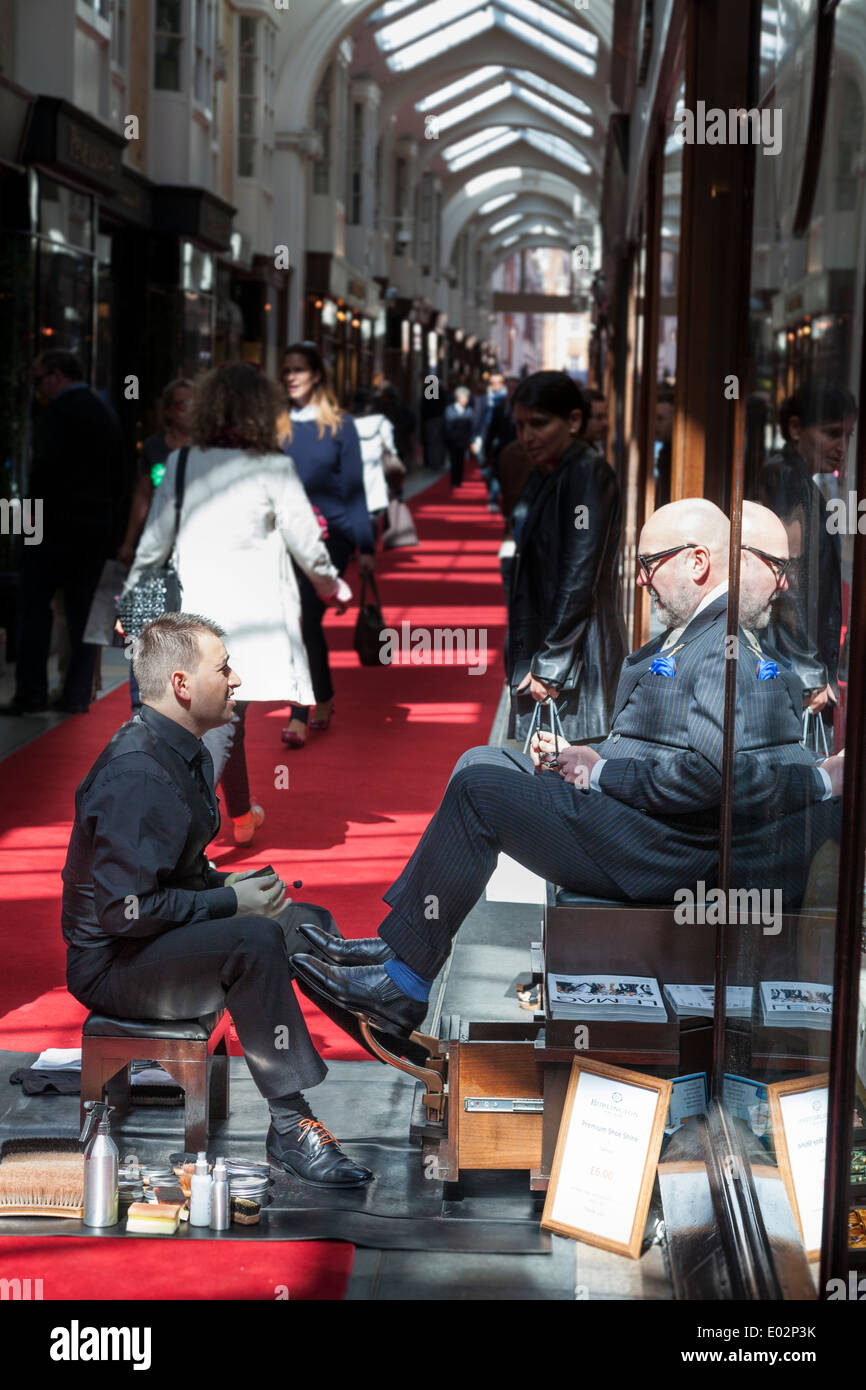 Shoe shine man polishing customers 