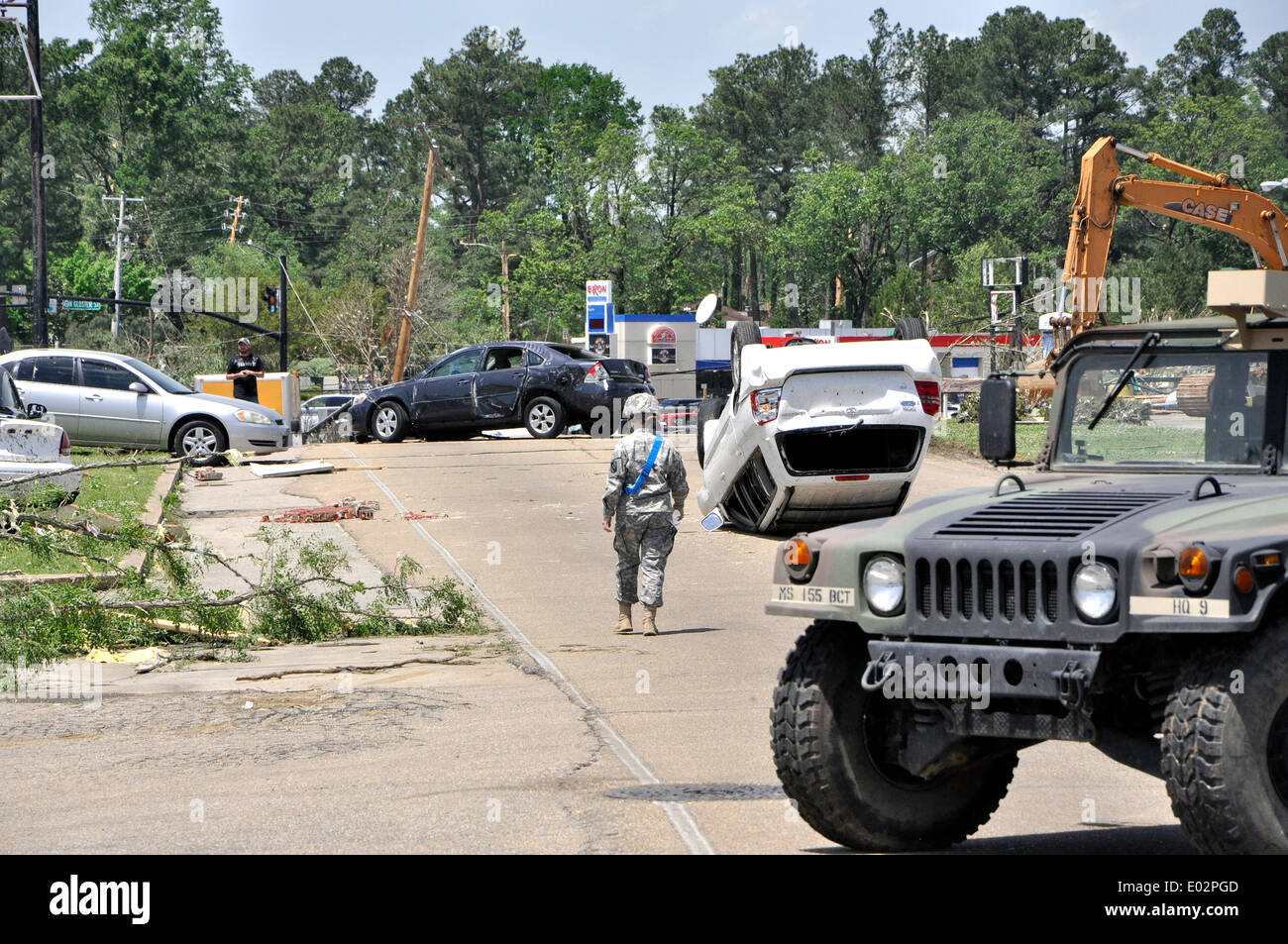 A US Army national guard soldier surveys damage on Green Street caused by tornadoes that swept across the southern states killing 35 people April 28, 2014 in Tupelo, Mississippi. Stock Photo