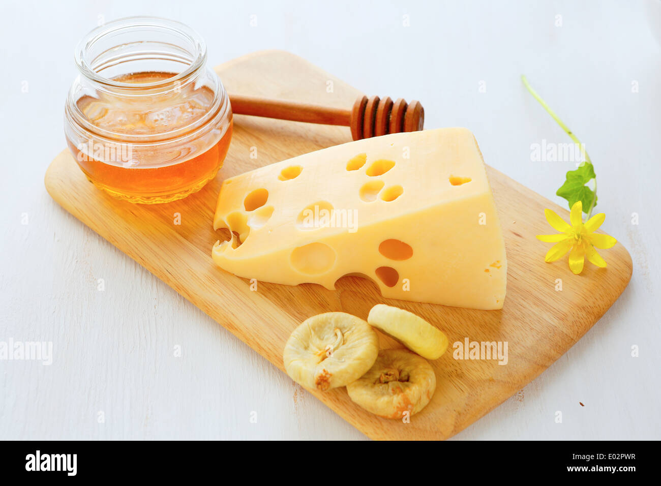 cheese with honey on a board, food closeup Stock Photo