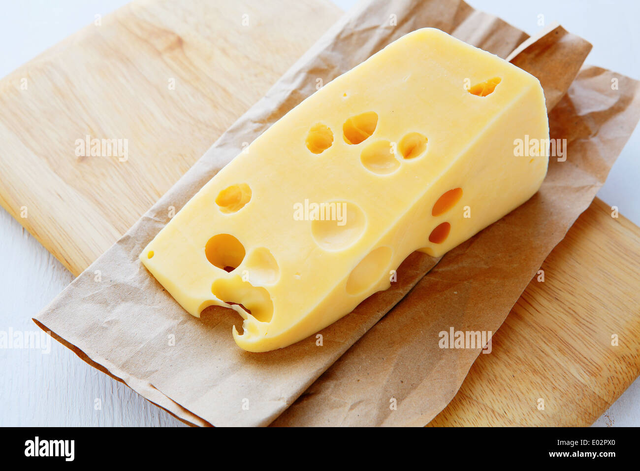 piece of cheese with holes, food closeup Stock Photo