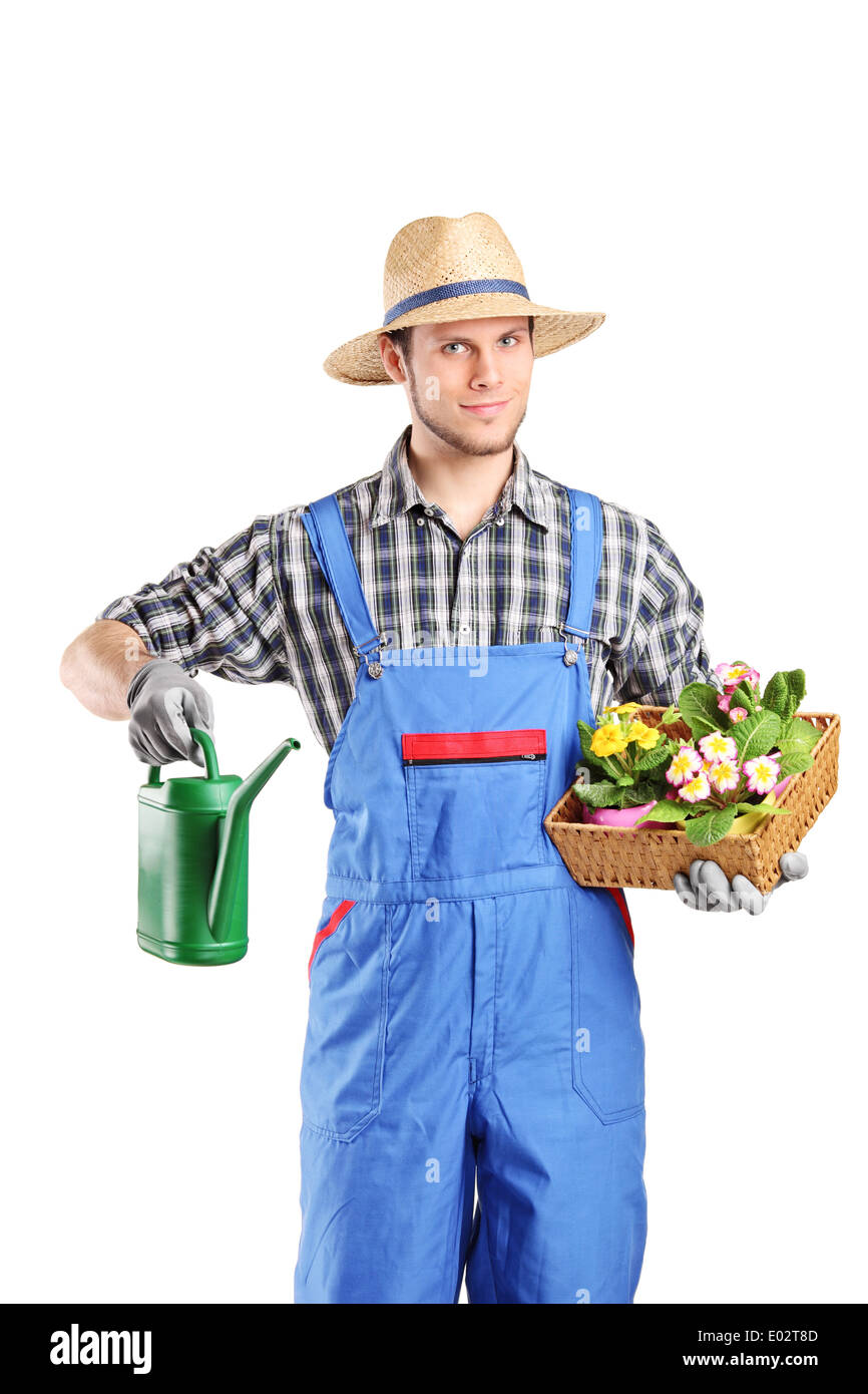 Male florist holding a watering can and flowers Stock Photo