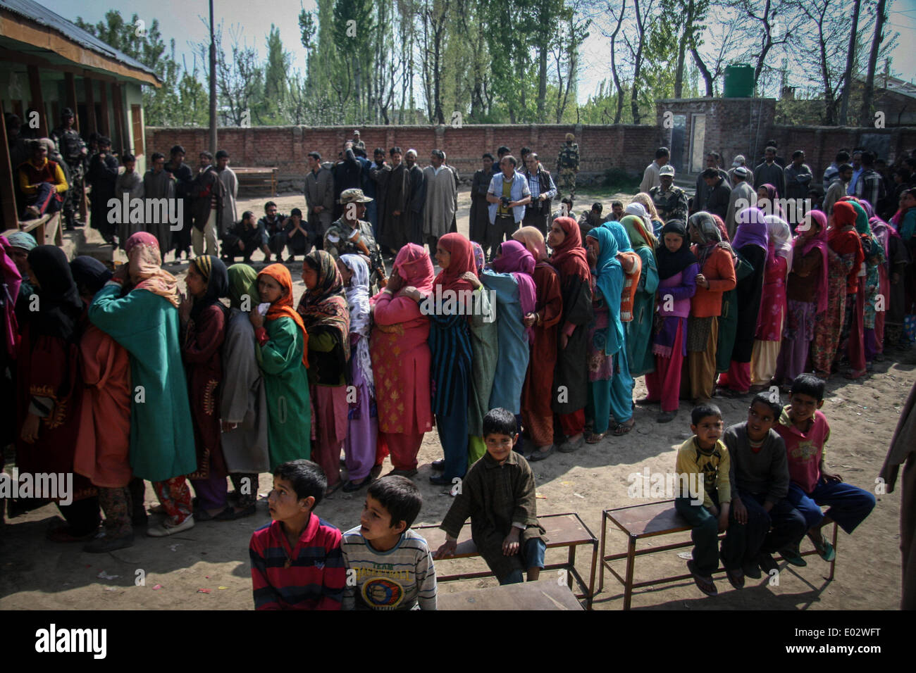Zawalpora, India. 30th Apr, 2014. Kashmiri residents wait to cast their ballot at a polling station at Budgam Distric on April 30, 2014. Security was tight in Srinagar, where separatist leaders have called for a poll boycott and militants have threatened violence against voters who cast their ballots. Hundreds of police and paramilitaries patrolled Srinagar's streets, which were mostly deserted except for a handful of voters. Credit:  Shafat Sidiq/NurPhoto/ZUMAPRESS.com/Alamy Live News Stock Photo