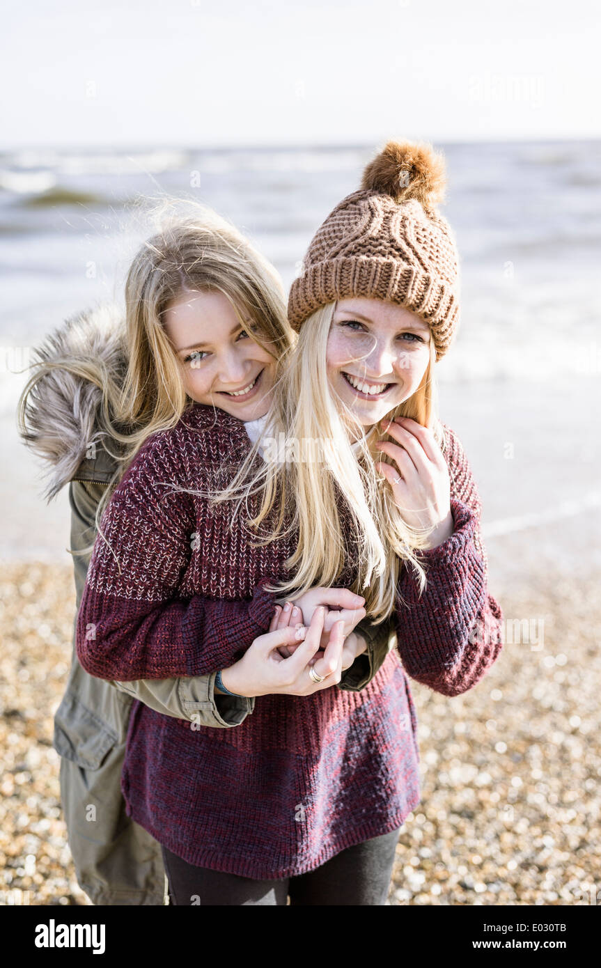 Two girls on the beach in winter. Stock Photo