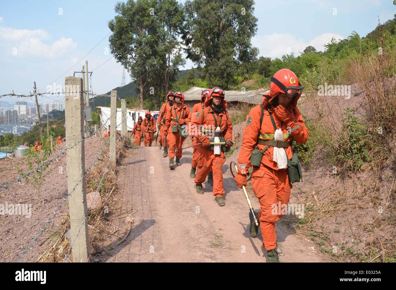 Dali, China. 30th Apr, 2014. Firefighters move towards a site where a forest fire reburned in Xiaguan Town in the city of Dali in southwest China's Yunnan Province, April 30, 2014. A forest fire here was extinguished by 8:10 a.m. yet reburned at 2:20 p.m.Wednesday. A total of 1,120 firefighters tackled the blaze, which burned an area of more than 200 mu (about 13.3 hectares). Credit:  Hu Shuli/Xinhua/Alamy Live News Stock Photo