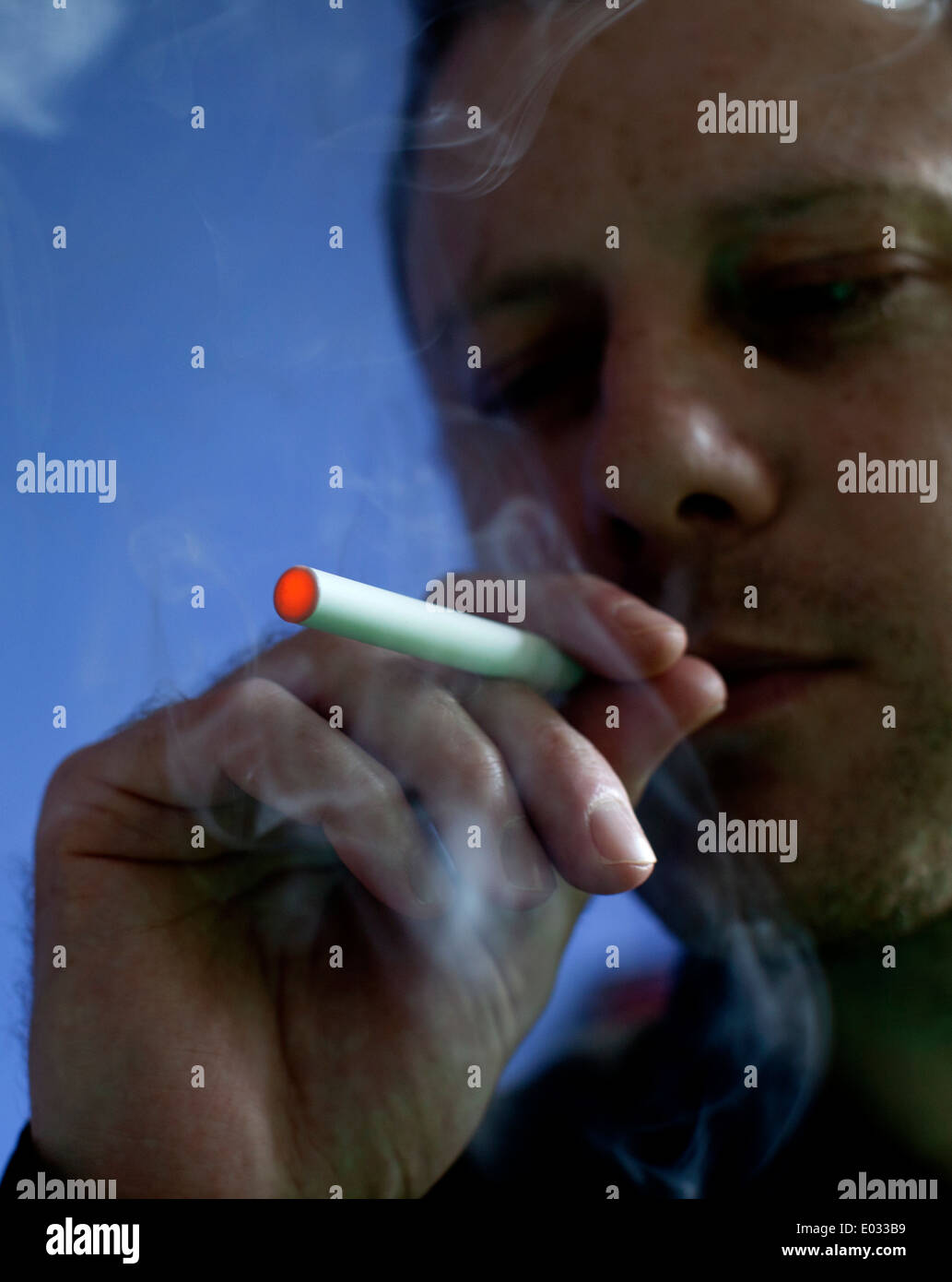 Man smoking a Puritane disposable e-cigarette, London MODEL RELEASED Stock Photo