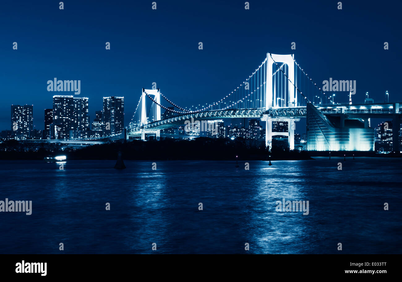 Tokyo Rainbow bridge nighttime scenery toned in blue. Odaiba, Tokyo, Japan. Stock Photo