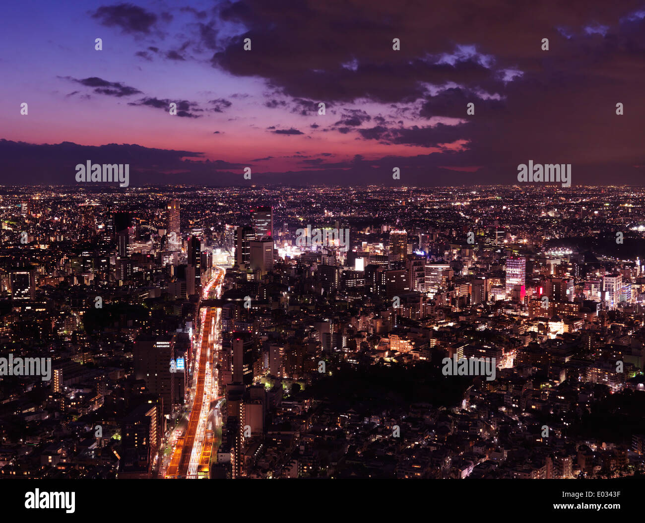 Dramatic twilight scenery of Tokyo city landscape lit with brightly lit highway, aerial view. Shibuya, Tokyo, Japan. Stock Photo