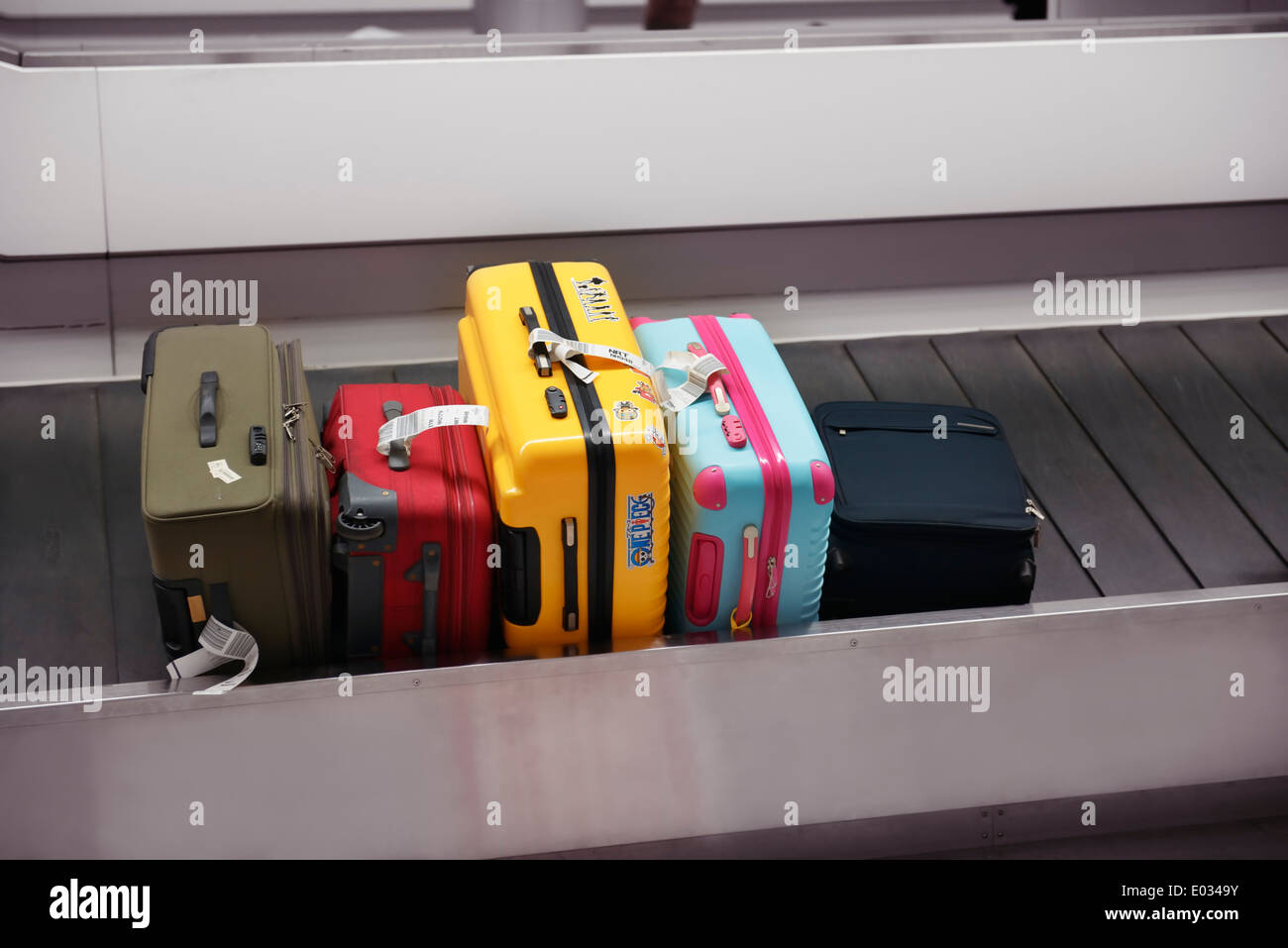 Colorful suitcases, luggage on airport baggage claim conveyor carousel, Narita International