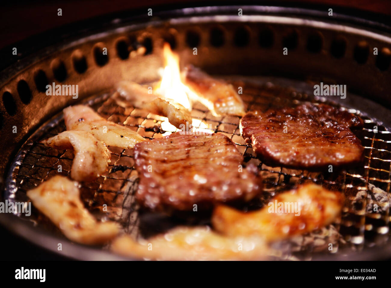 Meat being cooked at a Japanese grill restaurant. Yakiniku, Japanese barbecue. Stock Photo