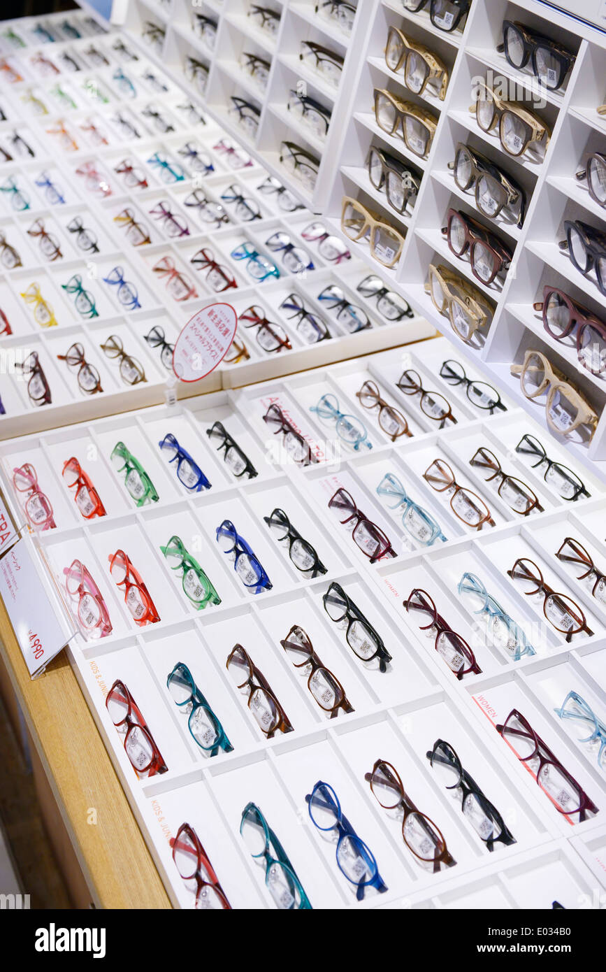 Eyeglasses with colorful and wooden frames on display in a store in