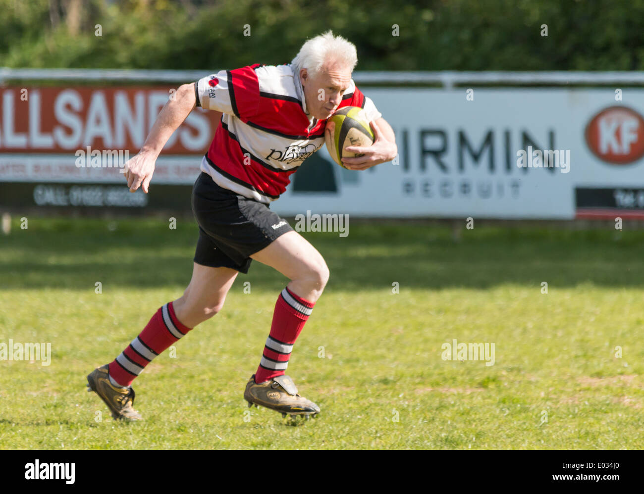 Mature Rugby Player Running with Ball Stock Photo