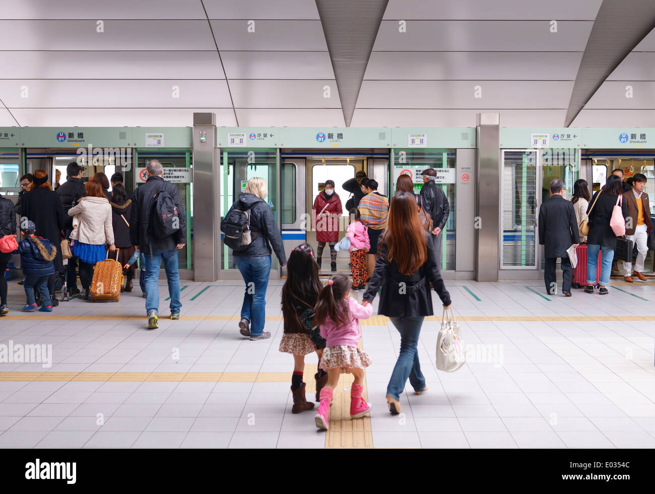 People boarding New Transit Yurikamome fully automated train at Shimbashi station, Tokyo, Japan. Stock Photo