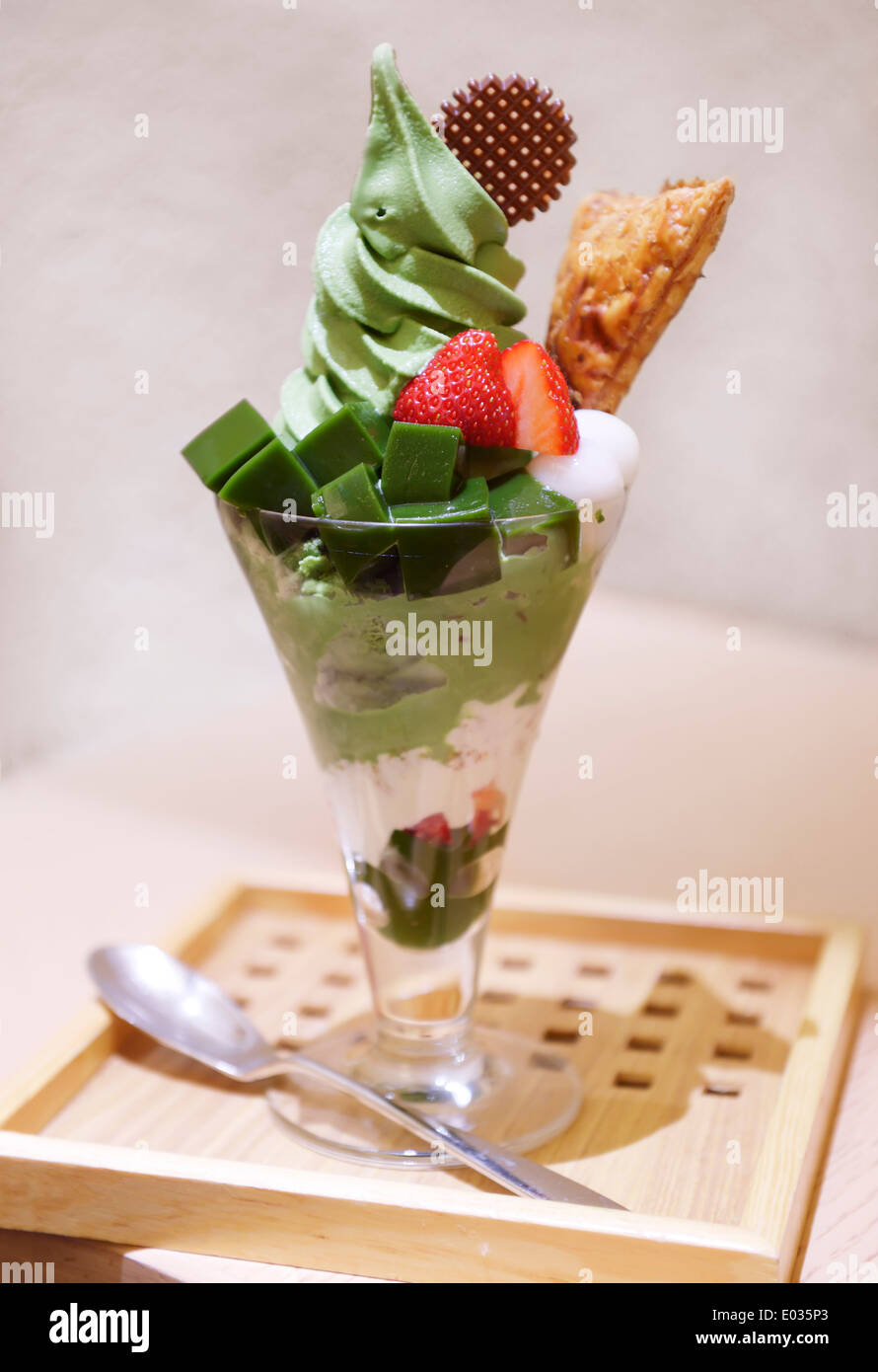 Matcha parfait, green tea icecream and fruit dessert in a glass in Japanese cafe Stock Photo