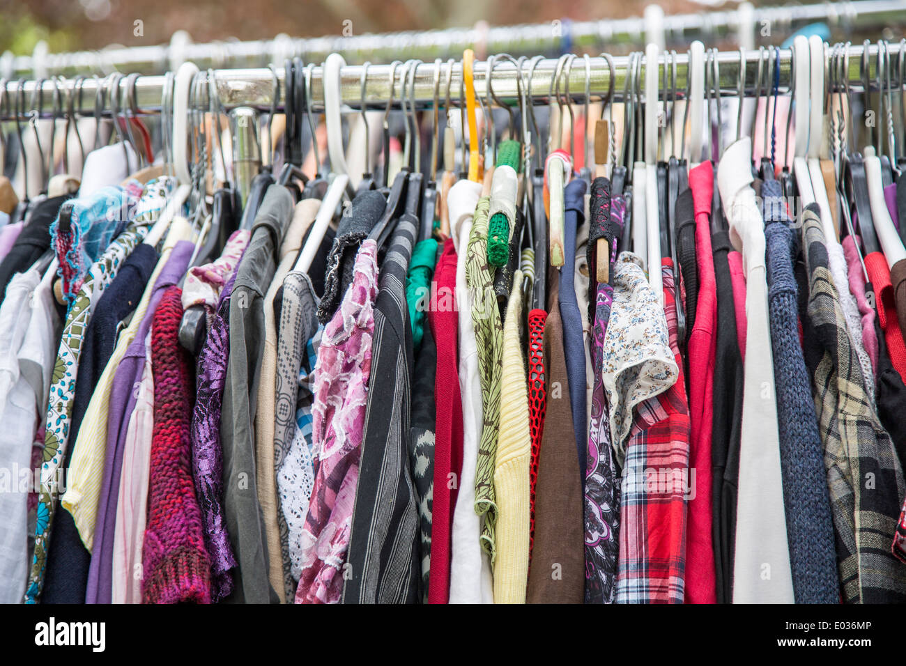 clothes on a rack in a flea market . Stock Photo
