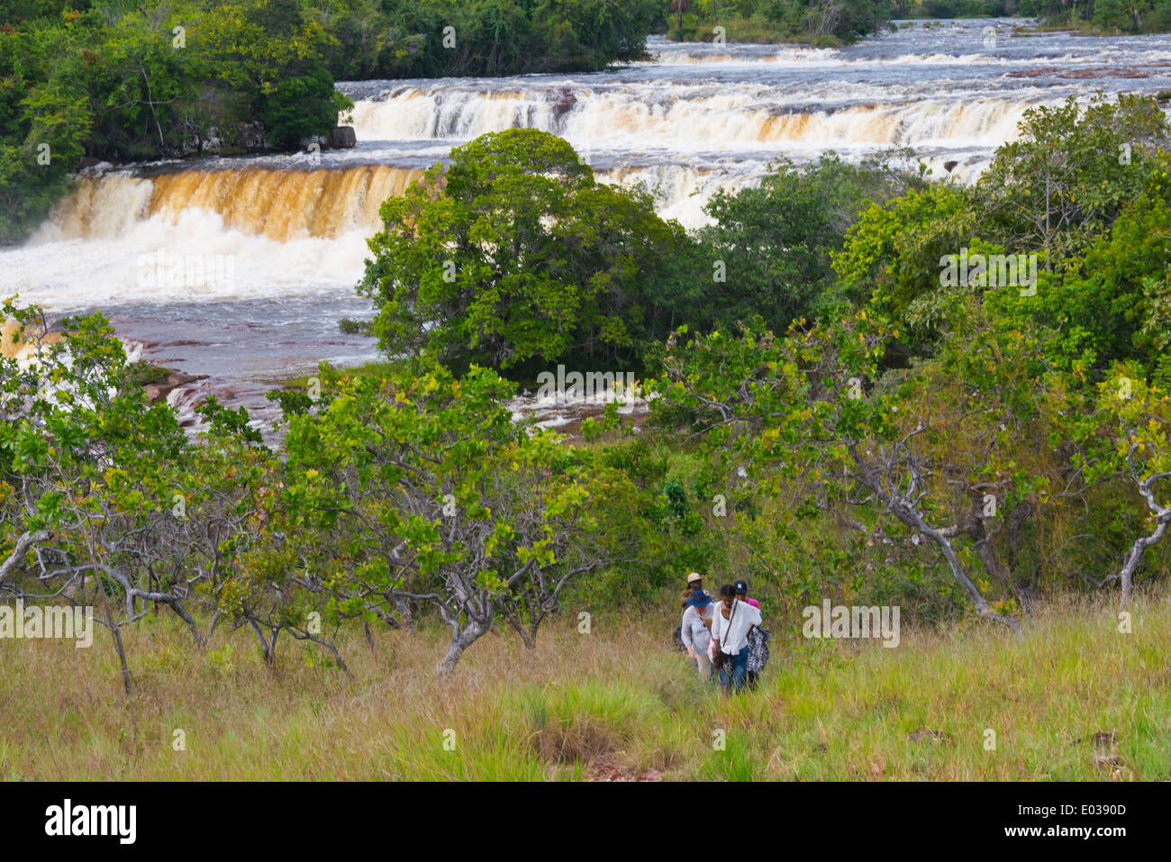 Tourists with Orinduik Falls, Guyana Stock Photo