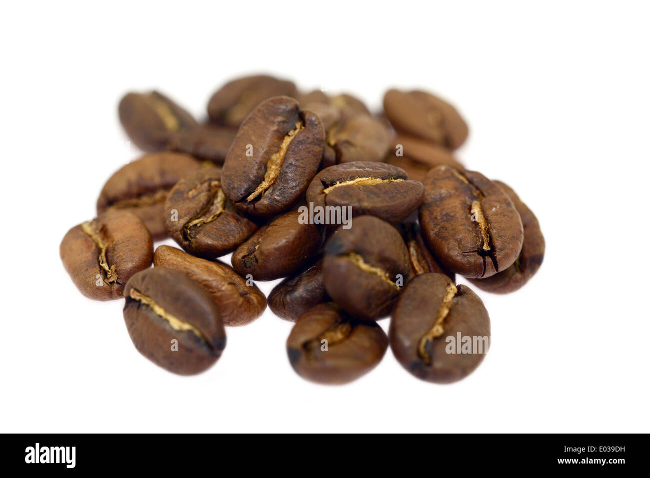 heap of brown coffee beans isolated on white background Stock Photo - Alamy