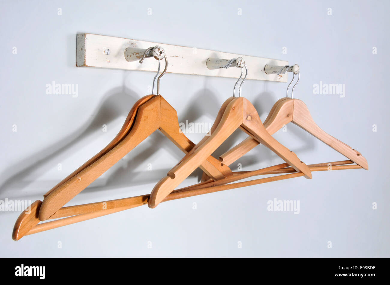 coat hangers on wooden coat stand rack Stock Photo