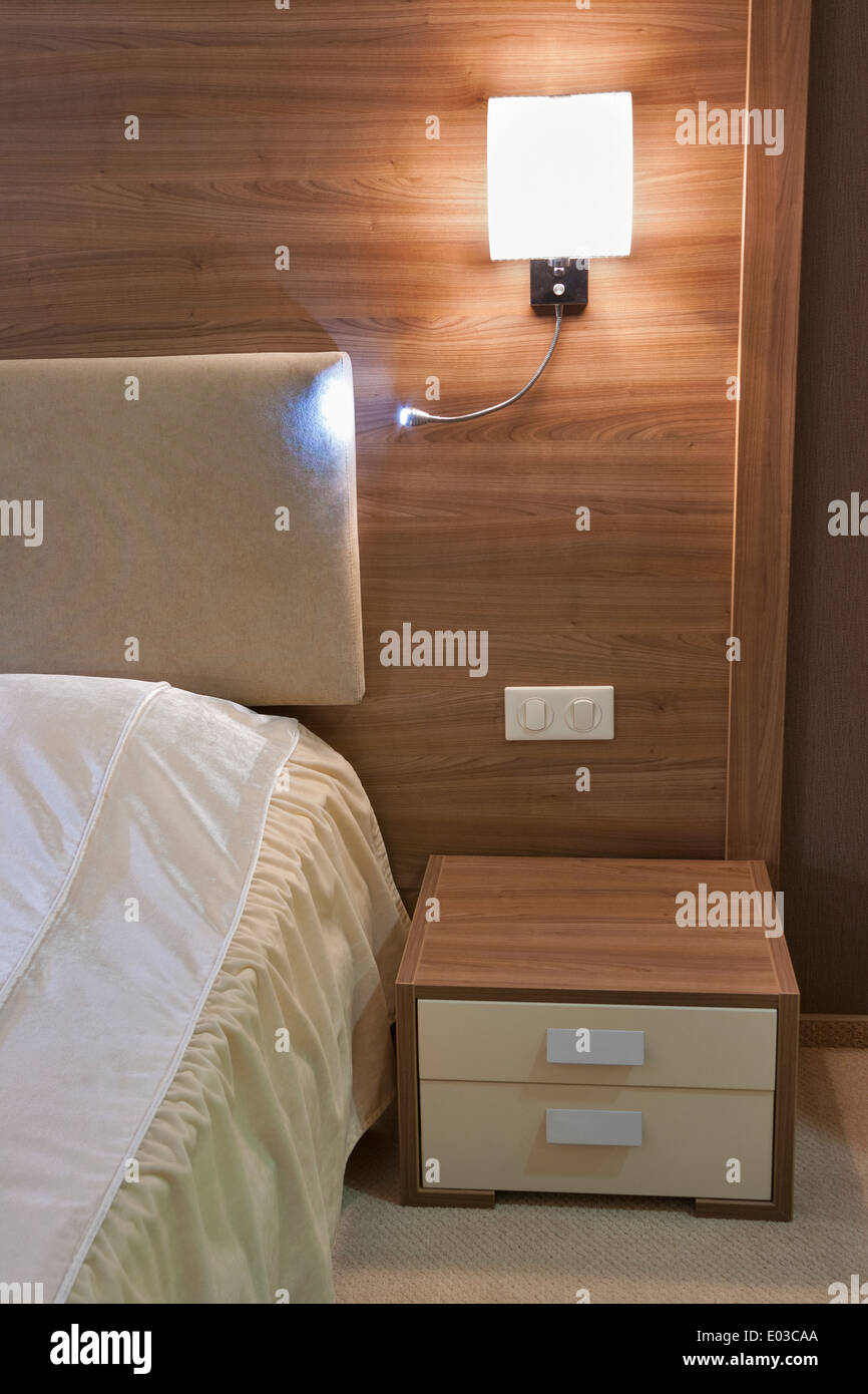 sleeping room with double bed, nightstandand and lamp Stock Photo